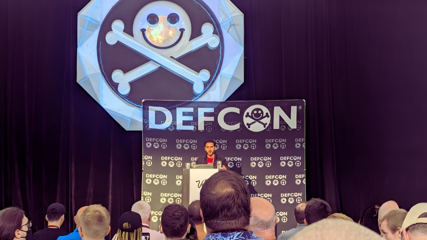 Thomas Roccia speaking on stage at DEF CON